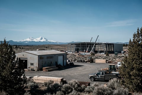 Bend Oregon high desert landscape with volcanic peaks visible, clear high-altitude light, commercial growth